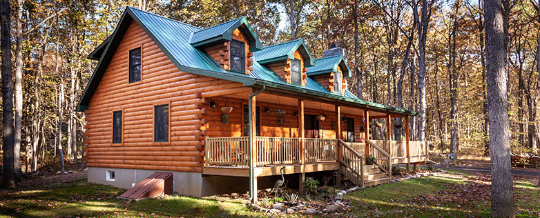 log cabin home with wrap around porch