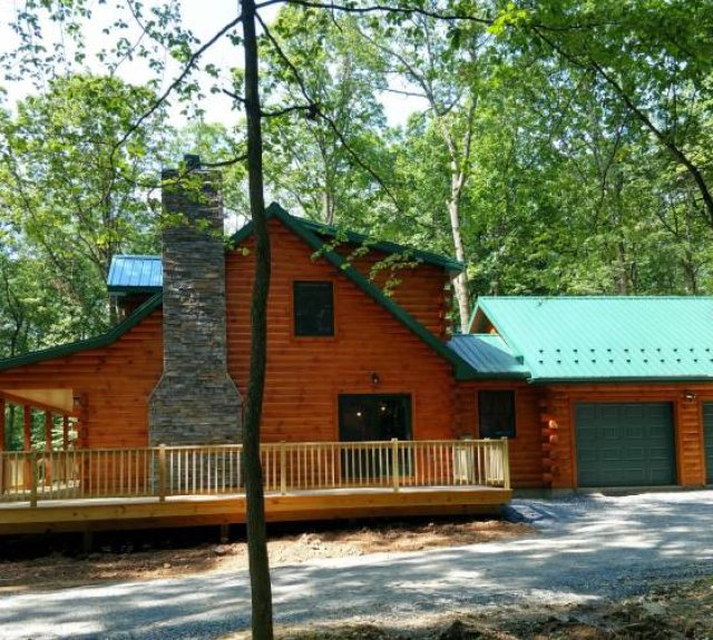 cabin floor plans with 3 bedrooms exterior with green roof in the woods